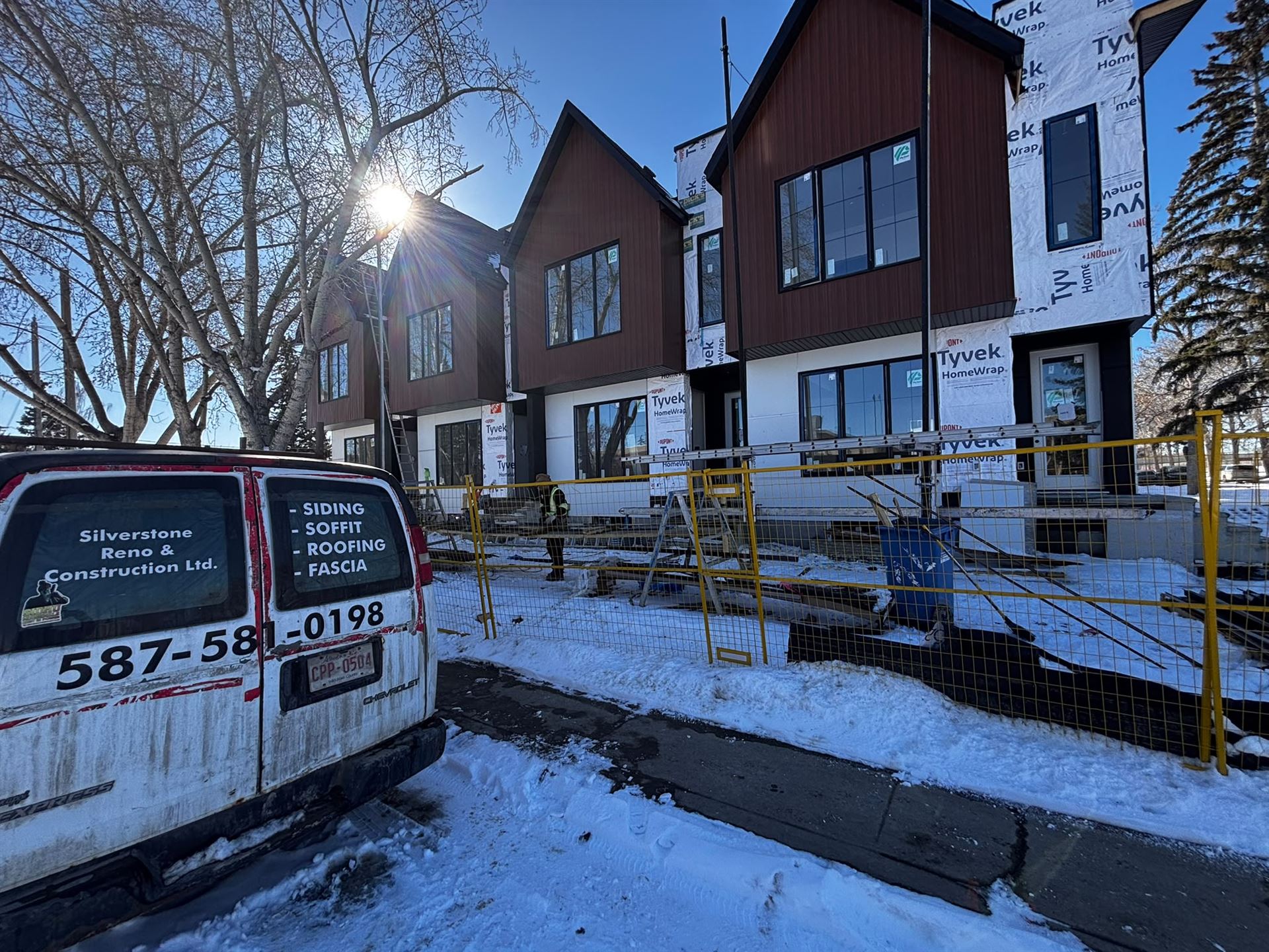 Silverstone company van on site at a Calgary townhome siding project