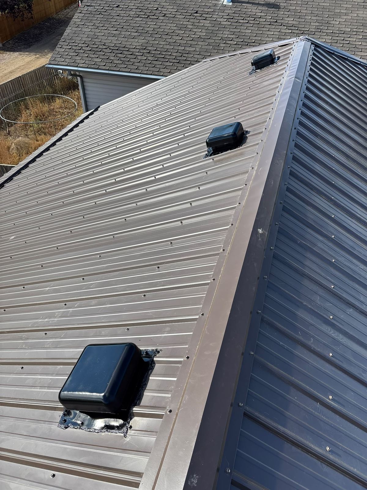 Brown metal roofing with new vents on a Calgary-area home