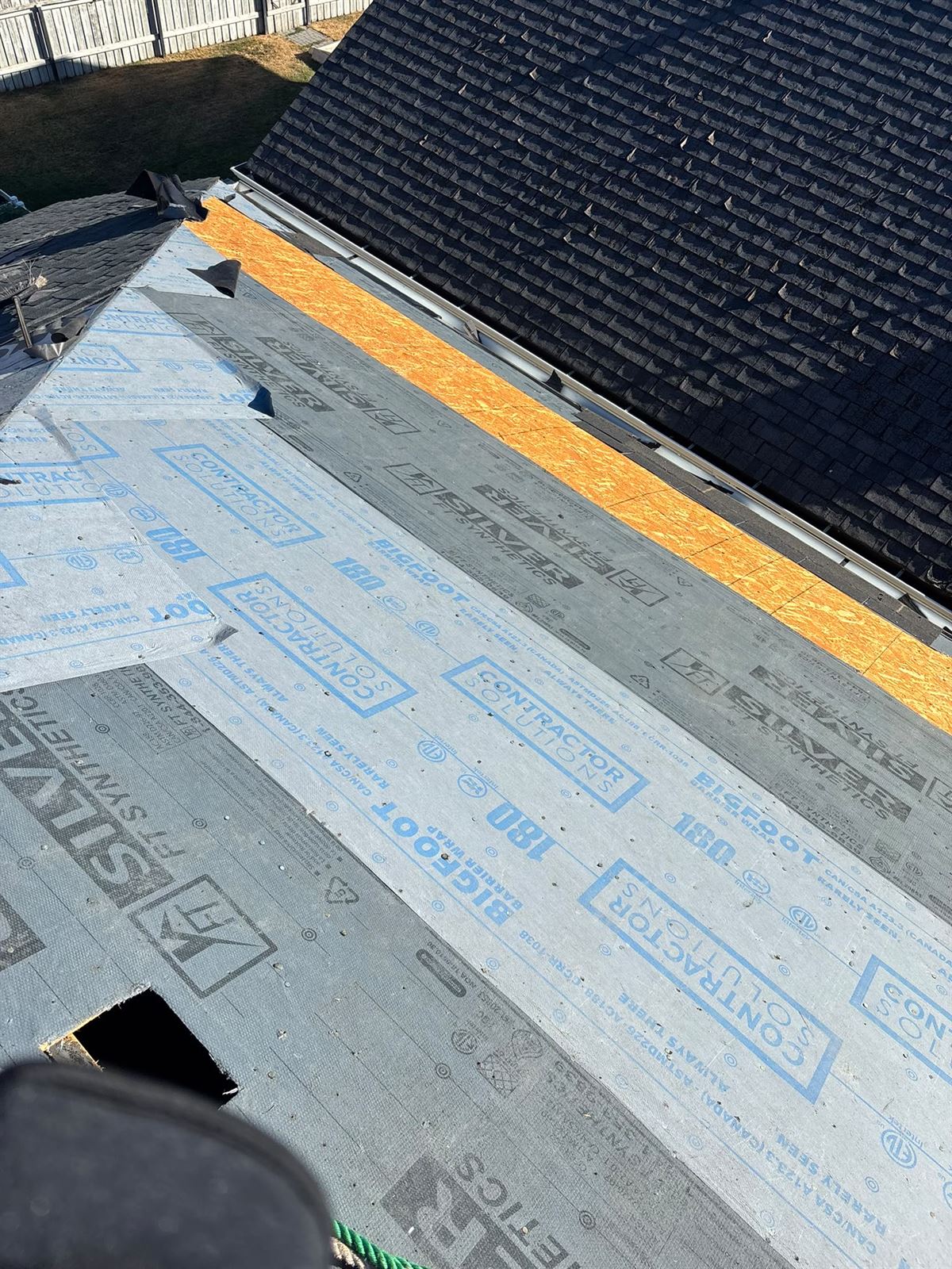 New OSB roof deck and synthetic underlayment during a re-roof