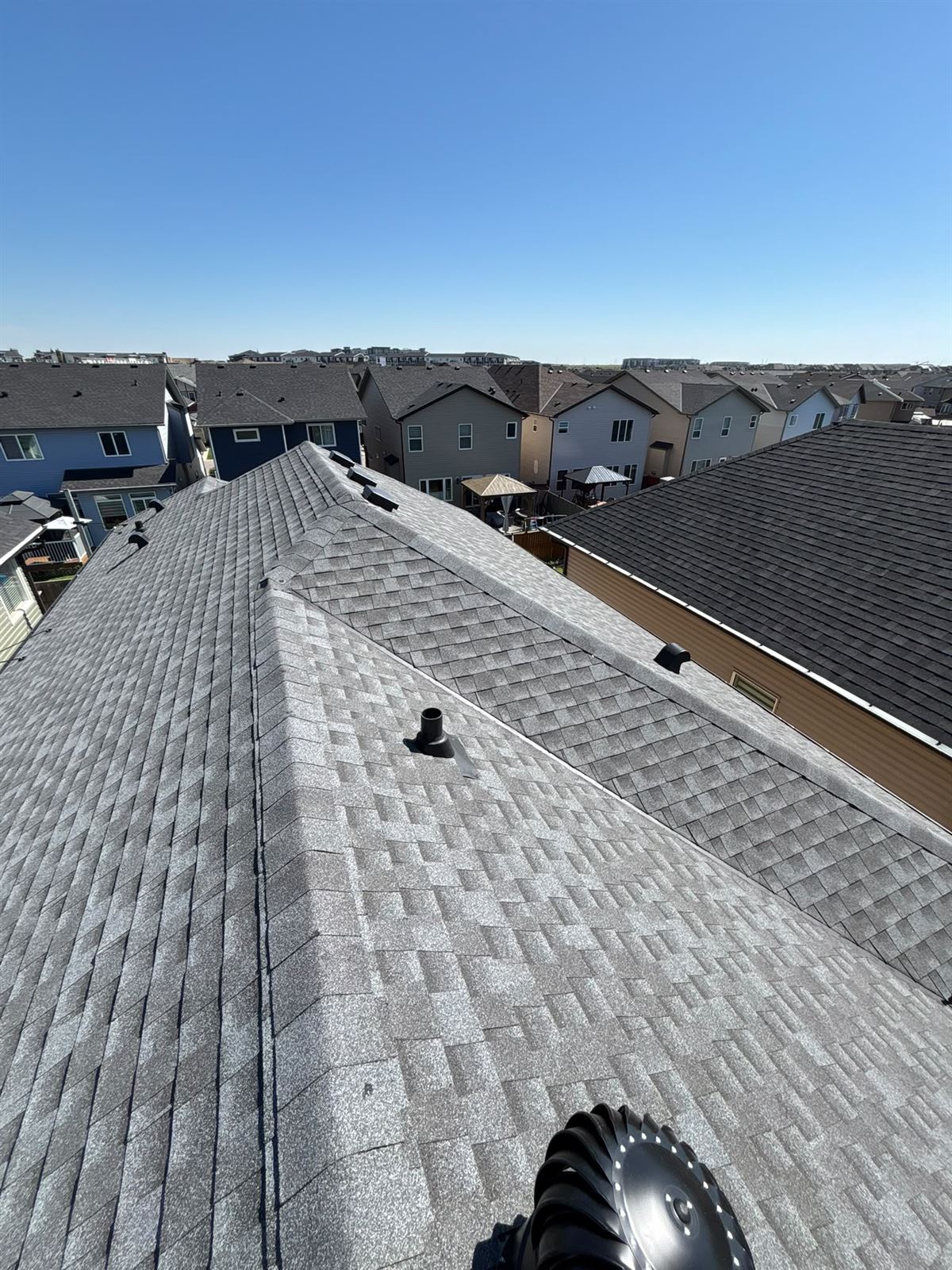 Ridge line and turbine vent on a completed Calgary roof