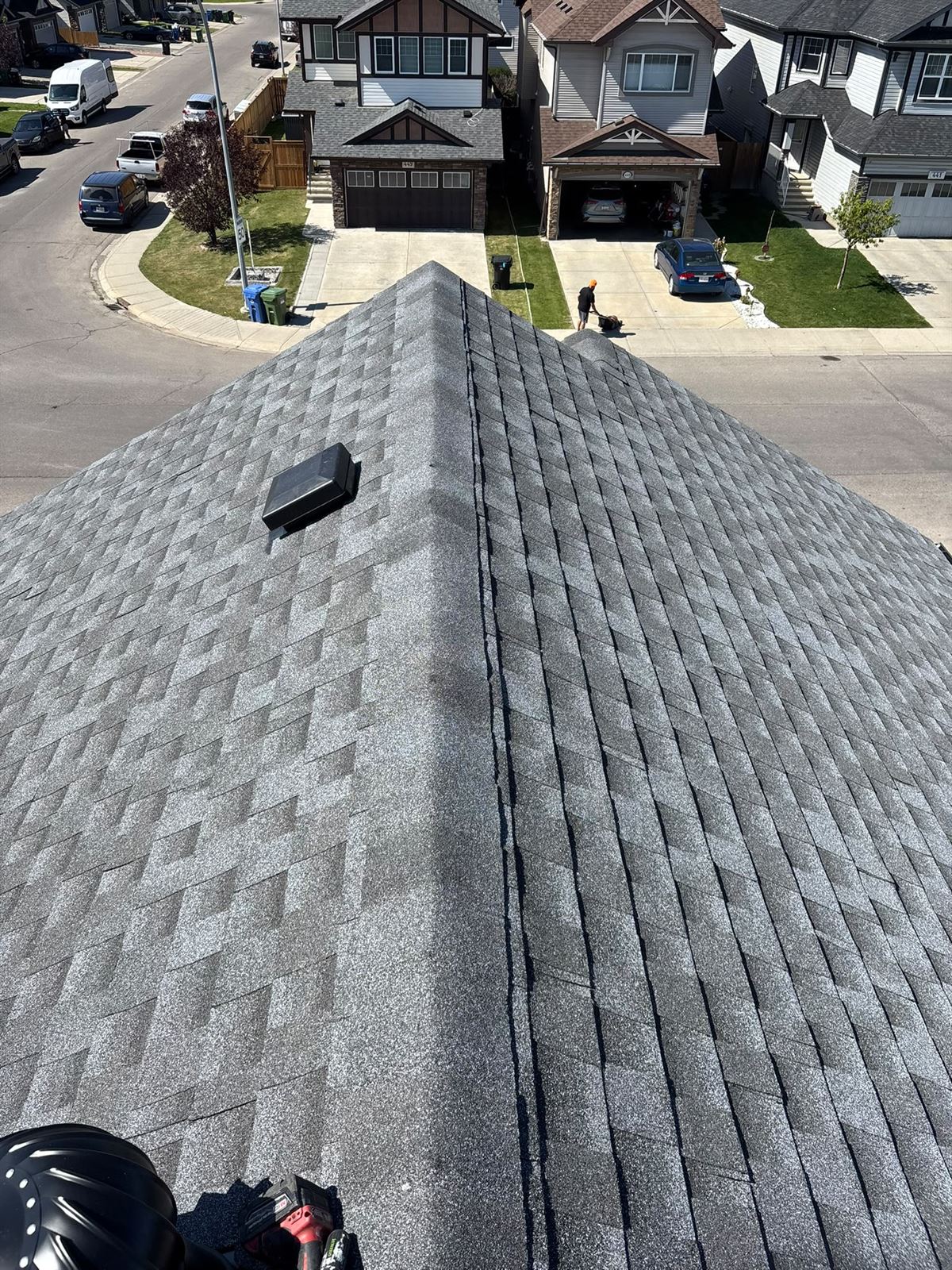 Ridge view of a completed two-tone shingle roof