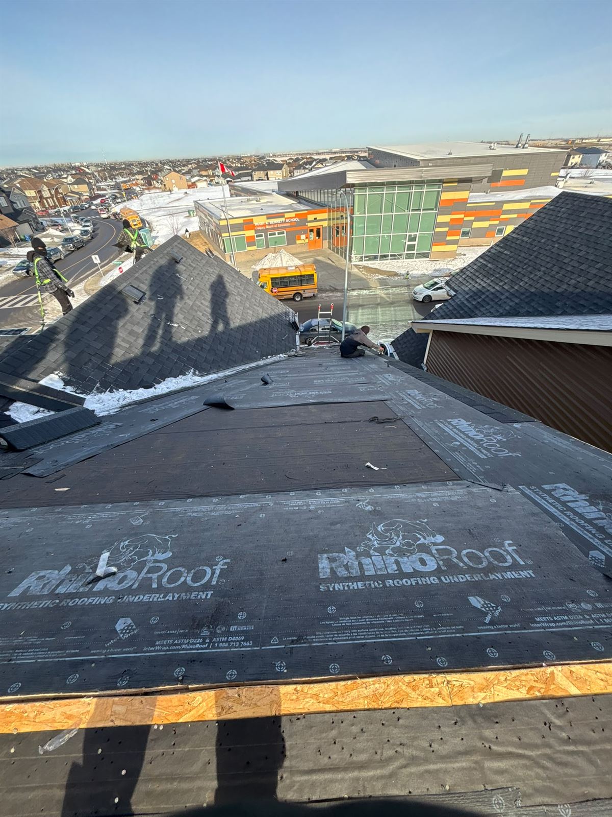Synthetic underlayment installed across a Calgary roof before shingles