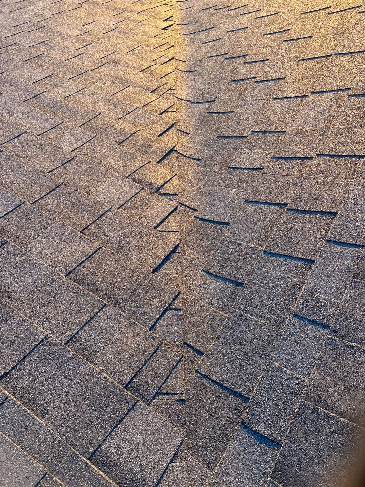 Closed-cut shingle valley detail on a completed roof in evening light