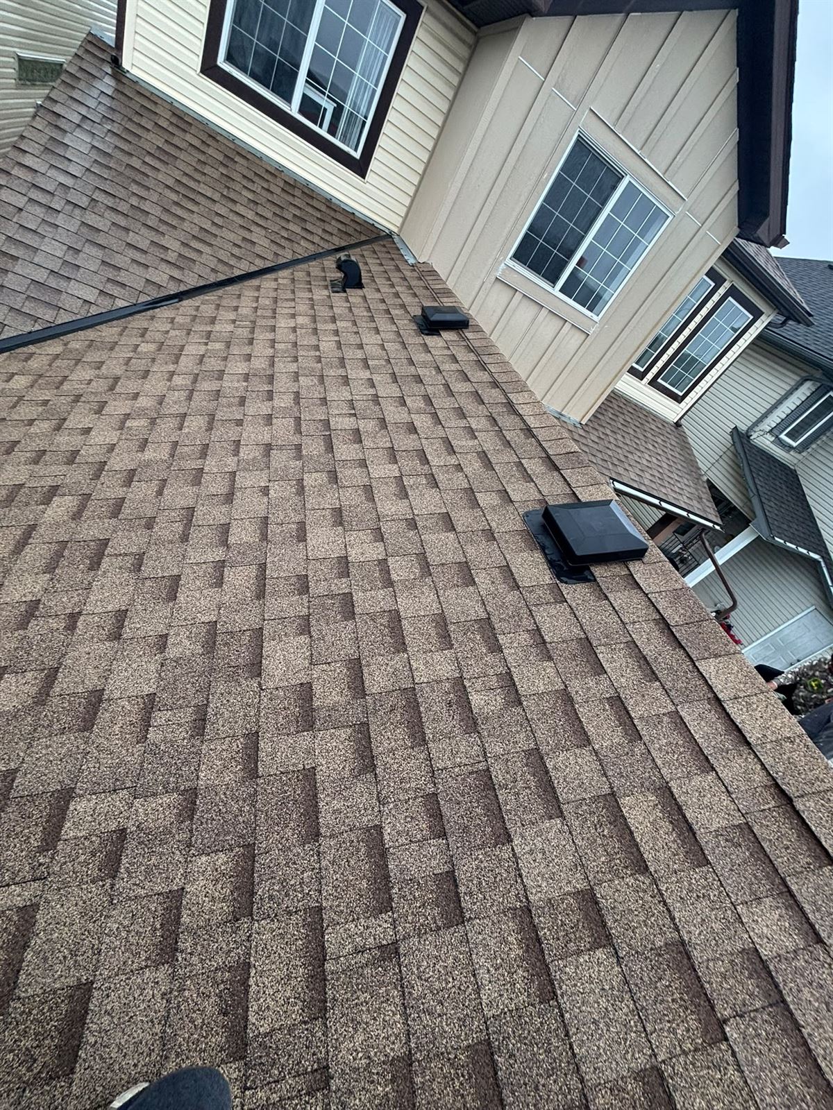 Roof vent and shingle detail on a completed installation