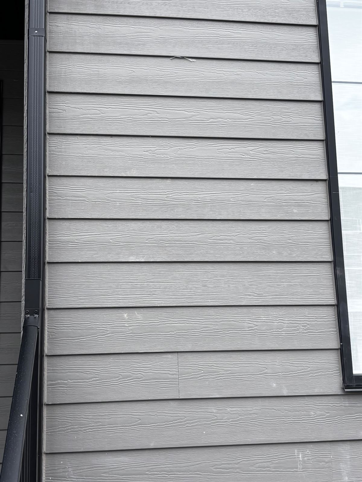 Grey lap siding texture with black downpipe detail