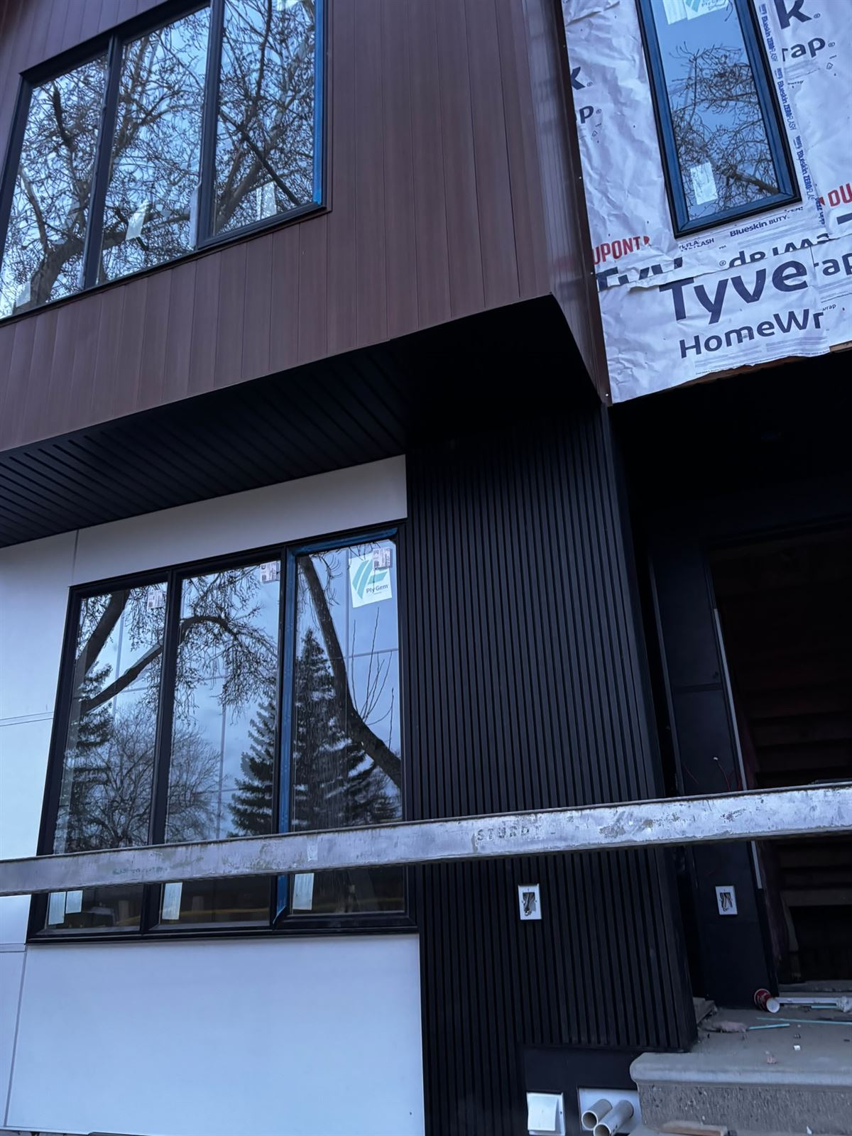 Wood-look panel siding and new window detail on a modern exterior