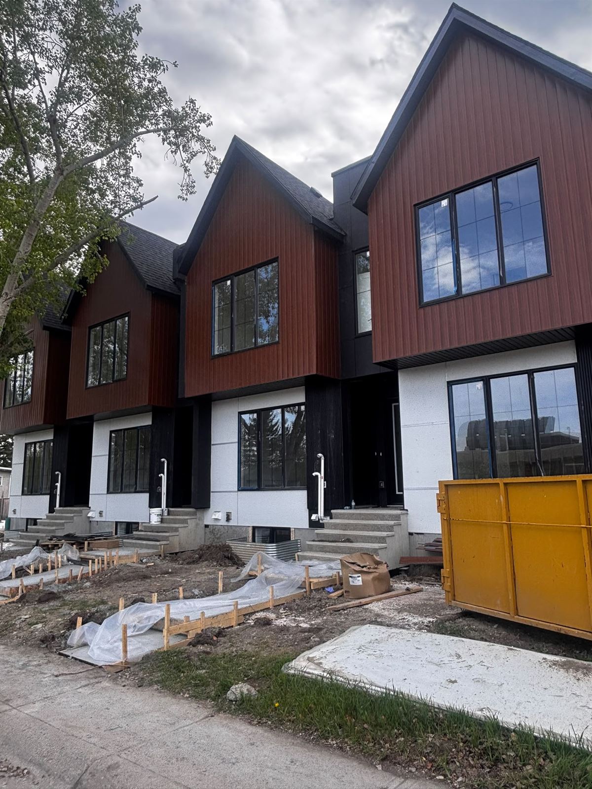 Row of finished townhomes with wood-tone gables